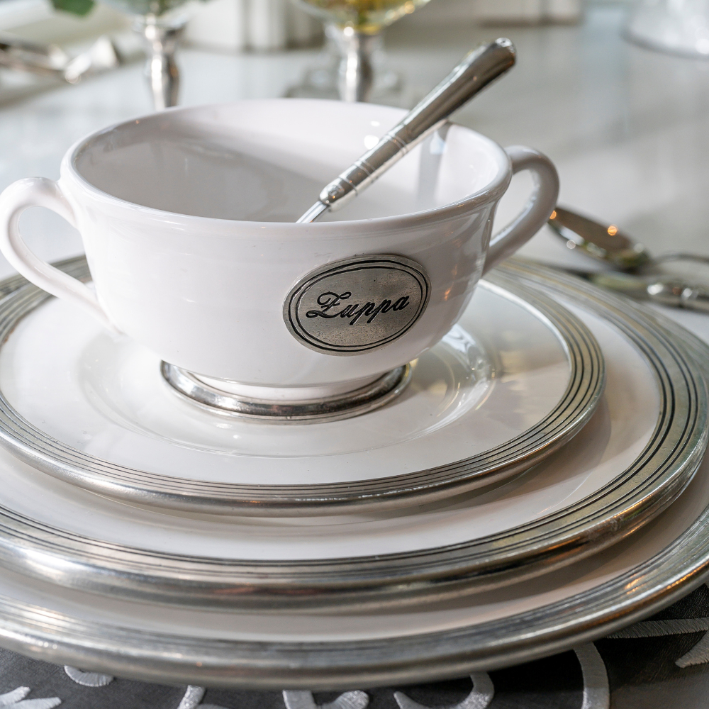 Stack of Tuscan dishes with a Zuppa soup bowl on top