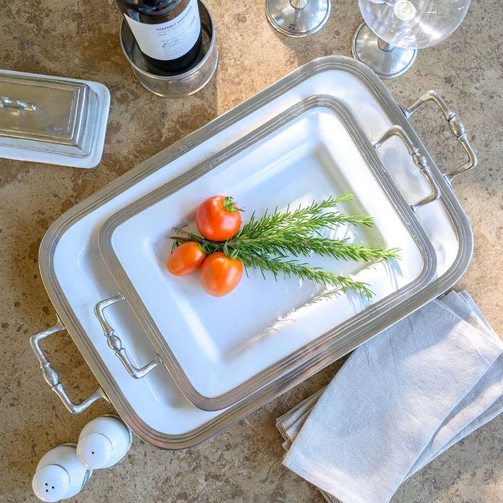 Two Sizes of our Tuscan Rectangular pewter tray with handles with tomatoes and rosemary on a stone surface