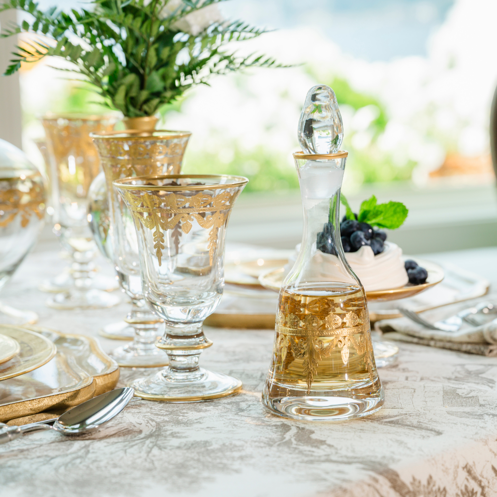 Vetro Gold Small Decanter sitting on a table set with the Vetro Gold Collection