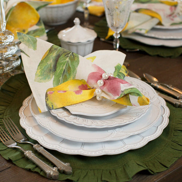 Arte Italica Bella Bianca beaded charger Italian stoneware plate stack with lemon napkin on green linen placemat