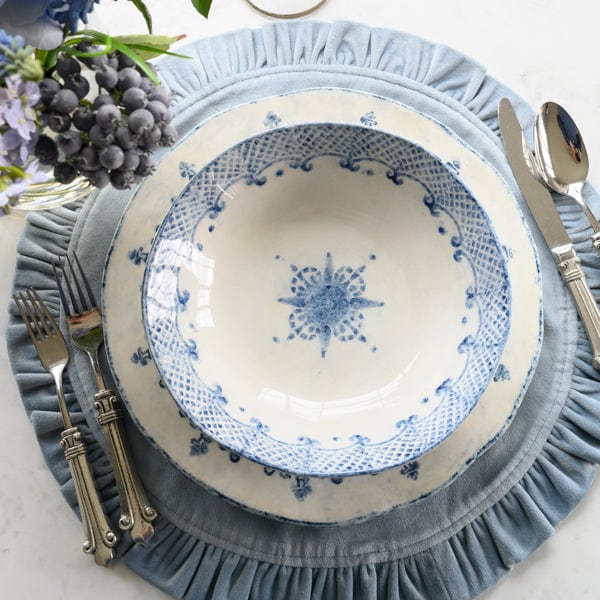 Arte Italica Burano pasta and soup bowl blue ceramic Italian hand painted dinnerware overhead view on table with blue velvet placemat
