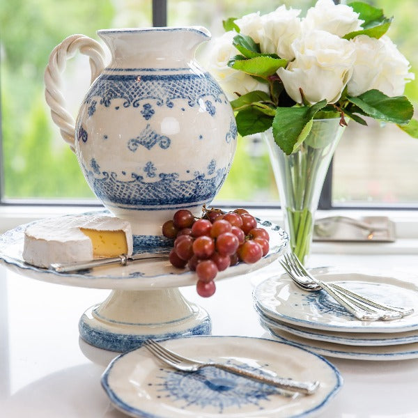 Arte Italica Burano small pitcher blue ceramic Italian hand painted dinnerware with grapes and cheese on cake stand