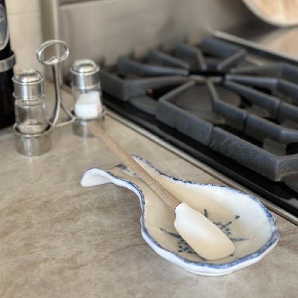 Arte Italica Burano spoon rest blue ceramic Italian hand painted table accessory on stove with spoon for cooking