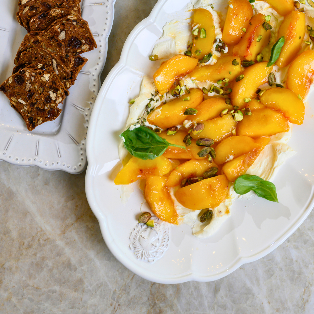 Arte Italica Renaissance Leone Oval Scalloped Platter White Handmade Italian Ceramic Lion Inspired Serving Platter overhead view peach desert on table