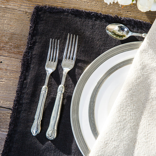 Detailed shot of black reversible linen placemat. 