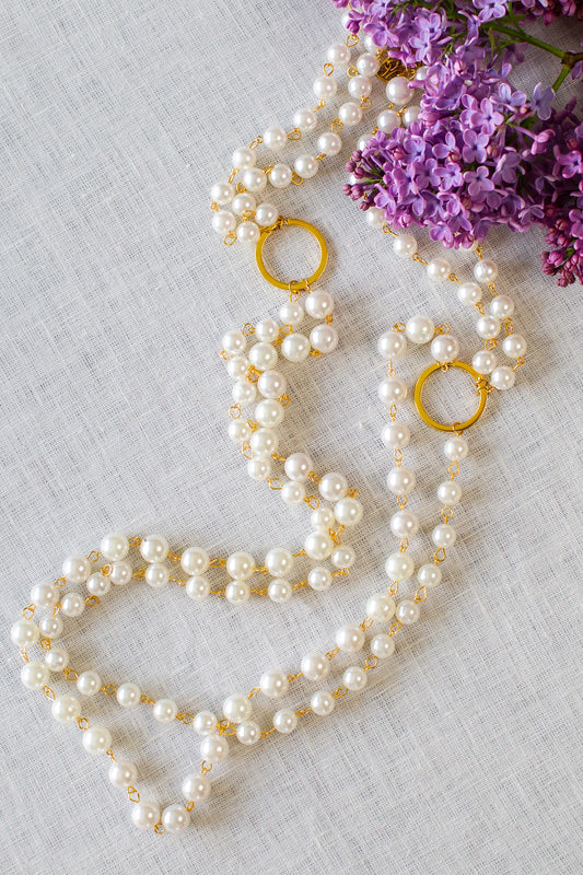 Detailed shot of gold double pearl strand necklace. --Arte Italica and Crown Linen Designs