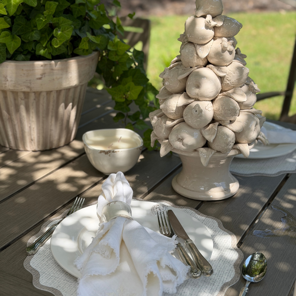 Scavo candle styled on an outdoor table. 
