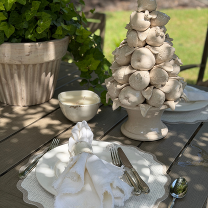 Scavo candle styled on an outdoor table. 