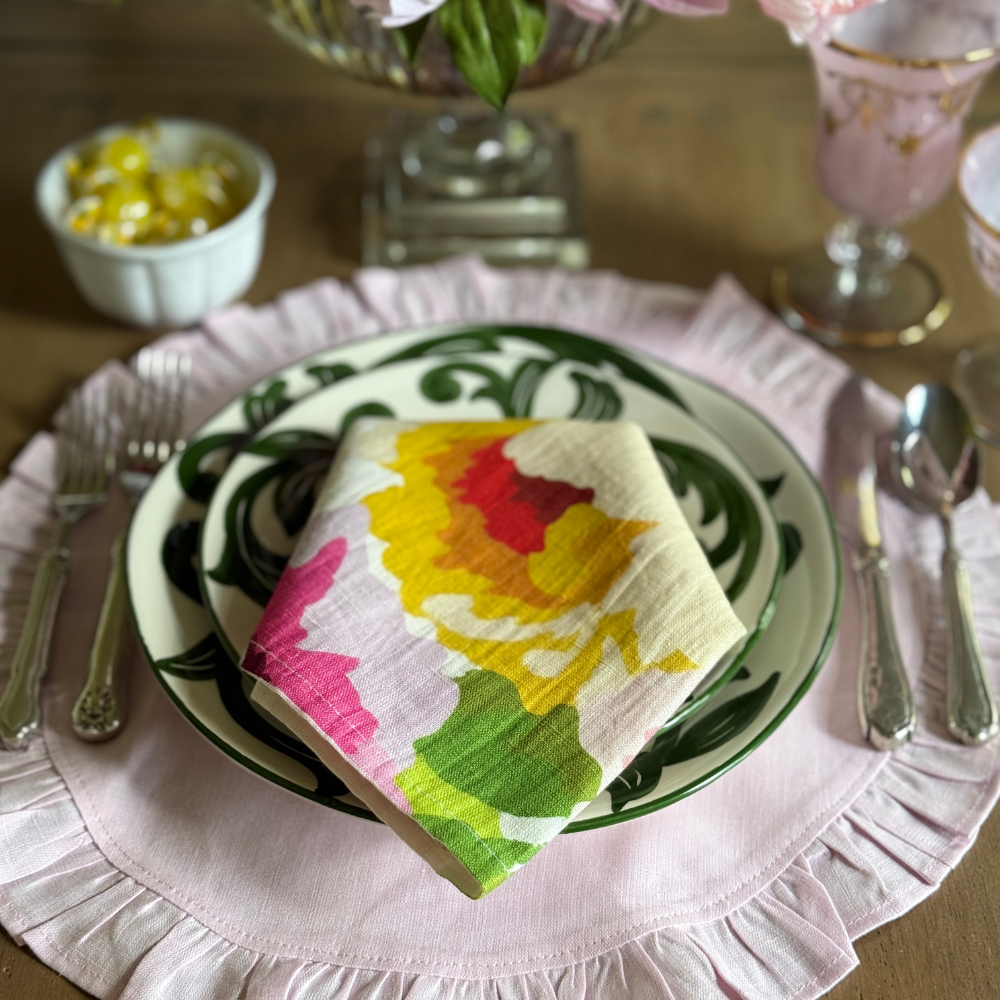 Portofino Garden napkin atop Al Fresco plates with pink place settings. 
