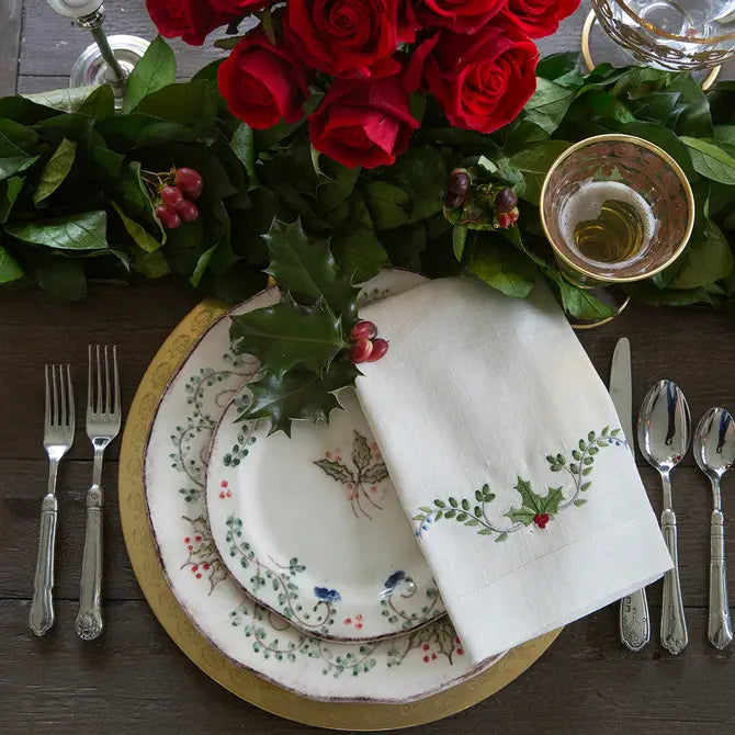 Medici Festivo Tri-Fold Napkin on holiday plates with red roses on a set table