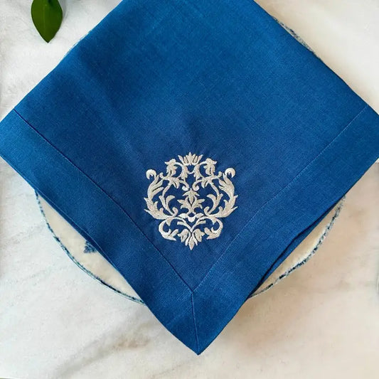 Damask Large Napkin in blue on plate with blue rim on marble countertop