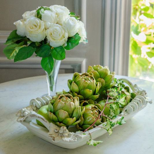 Antico Toscana Small rectangular dish with vine details on rim filled with artichokes on a white table with roses