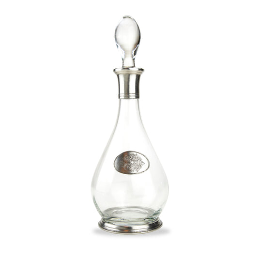 A glass decanter with a pewter base and neck and a tear drop shape decoration, including a glass stopper.