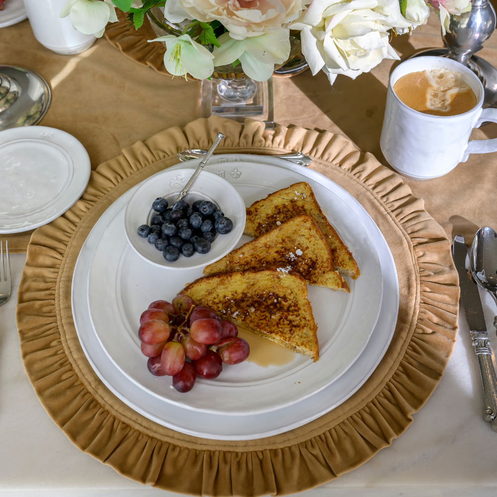 Breakfast with French toast, grapes, and a cup of coffee on a table with Firenze Stoneware dishes