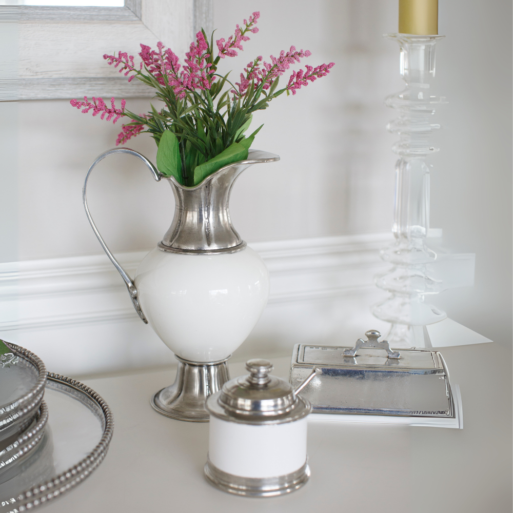Tuscan ceramic and pewter covered bowl, pitcher and covered butter dish on a counter