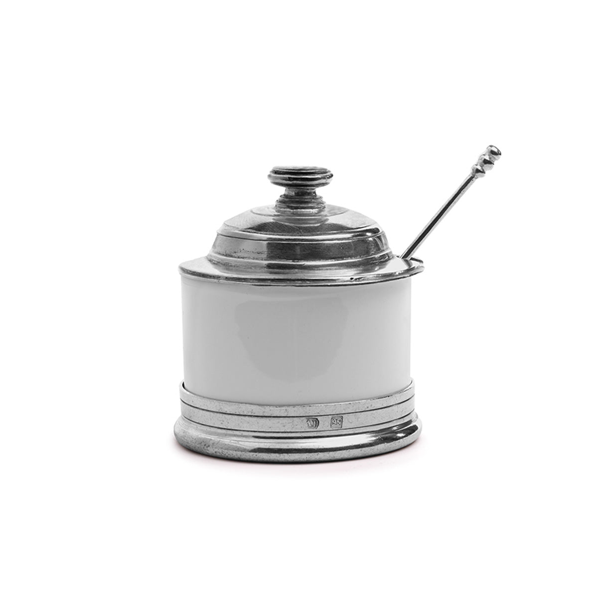 A round, white ceramic sugar bowl with a hand-rubbed pewter lid and a pewter spoon, featuring a white ceramic body with a silver patina against a white background.