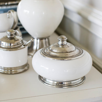 White ceramic Tuscan keepsake Box with pewter lid on a counter