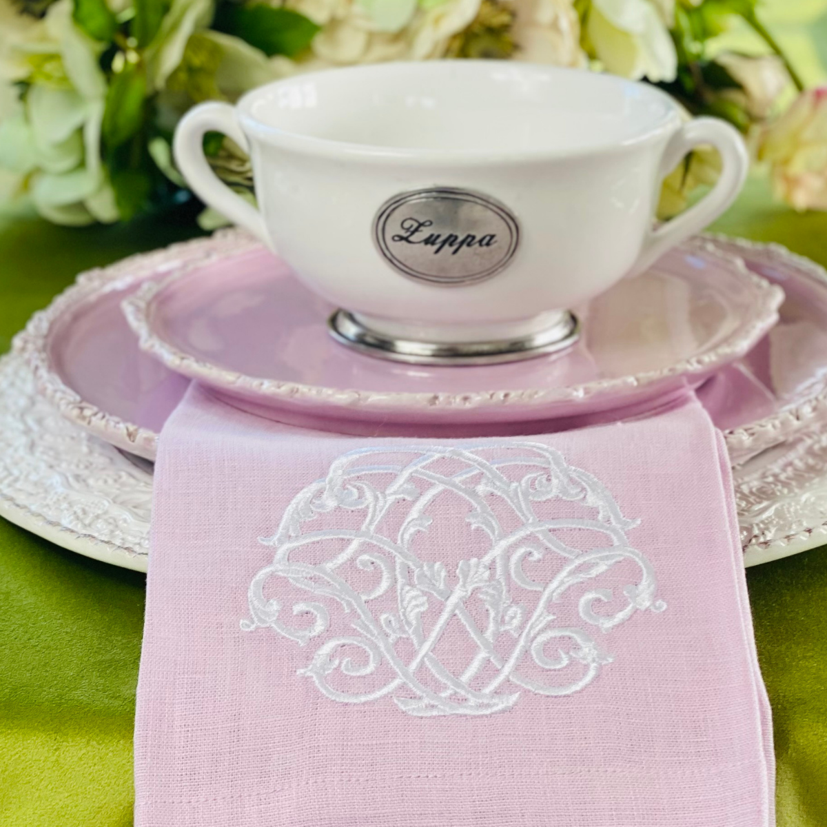 White Tuscan Zuppa Soup bowl with two handle on a stack of pink Imperial Plates with a Damask linen towel