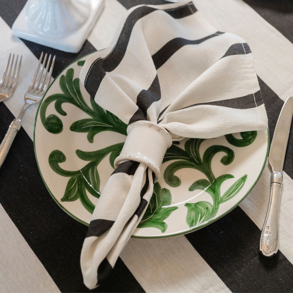 Up close shot of Al Fresco plate styled with black portofino linens. 