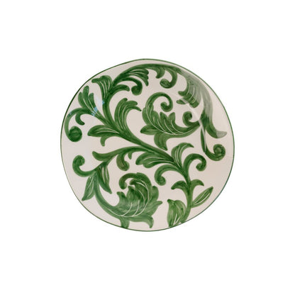 Ceramic plate with hand-painted green floral vine pattern on a white background
