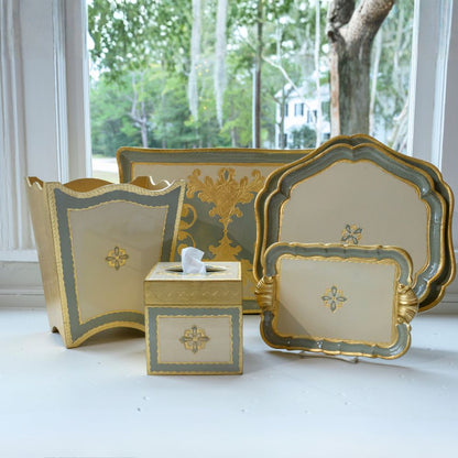 Florentino Wooden Baroque bathroom set with gold, cream and Villa Blue finish in front of a window with a view of trees.