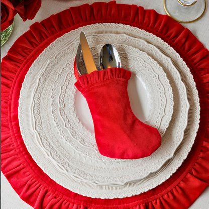 Arte Italica Finezza cream ceramic charger plate on red velvet placemat– elegant Italian dinnerware for timeless table settings