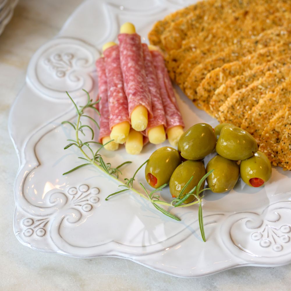 Bella Bianca white Scalloped Charger used as a Platter with salami, olives, and crackers.
