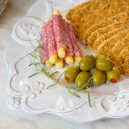 Bella Bianca white Scalloped Charger used as a Platter with salami, olives, and crackers.