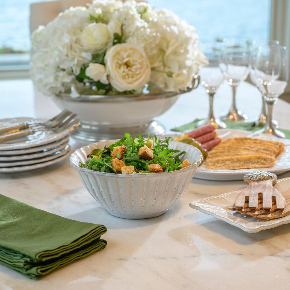 Dining table set with a Bella Bianca Small Serving bowl of salad with bread, and flowers.