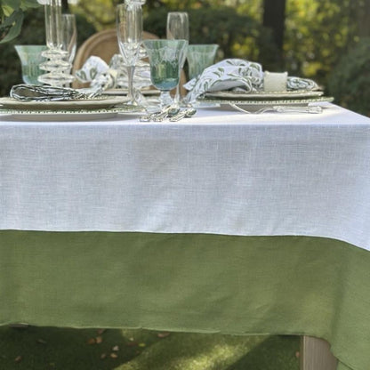 Table setting with green and white linen tablecloth outdoors
