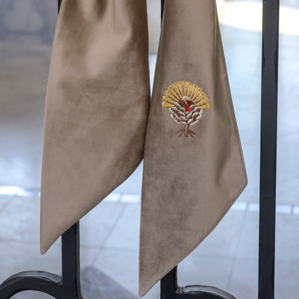 Close up of a Mocha Velvet Bow with embroidered Turkey design on door