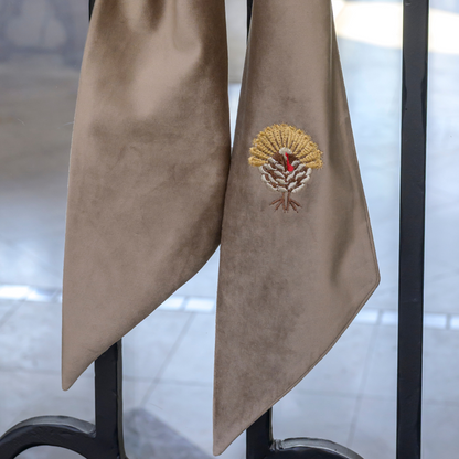 Close up of a Mocha Velvet Bow with embroidered Turkey design on door