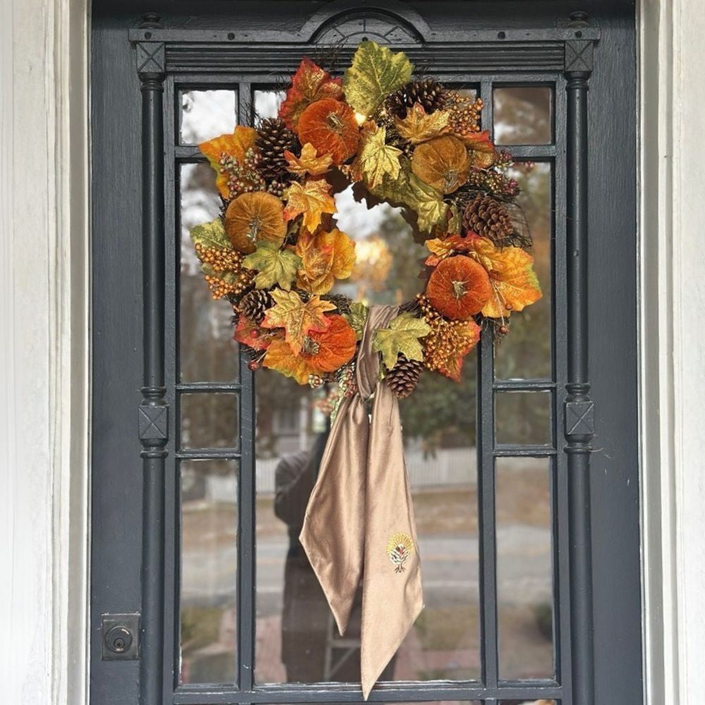 Autumn wreath with orange and green leaves with Mocha Velvet Bow with Turkey embroidery on a glass door