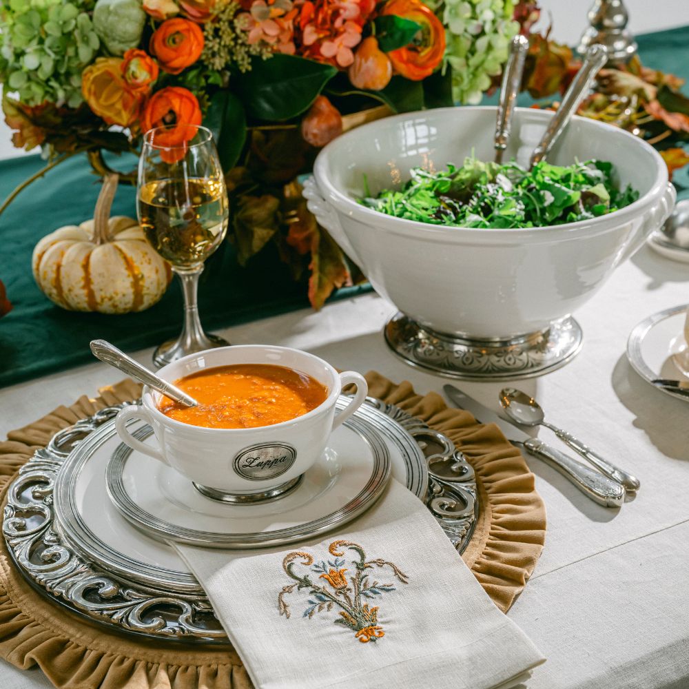 Set table with Tuscan Ceramic dishes with soup, salad, and flowers with a Villa Estate linen Tri-fold Napkin