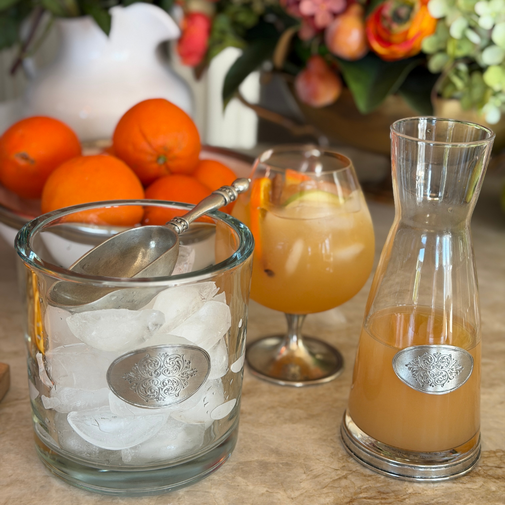 Arte Italica Damasco large glass vessel used as an ice bucket alongside a Damasco carafe filled with orange juice