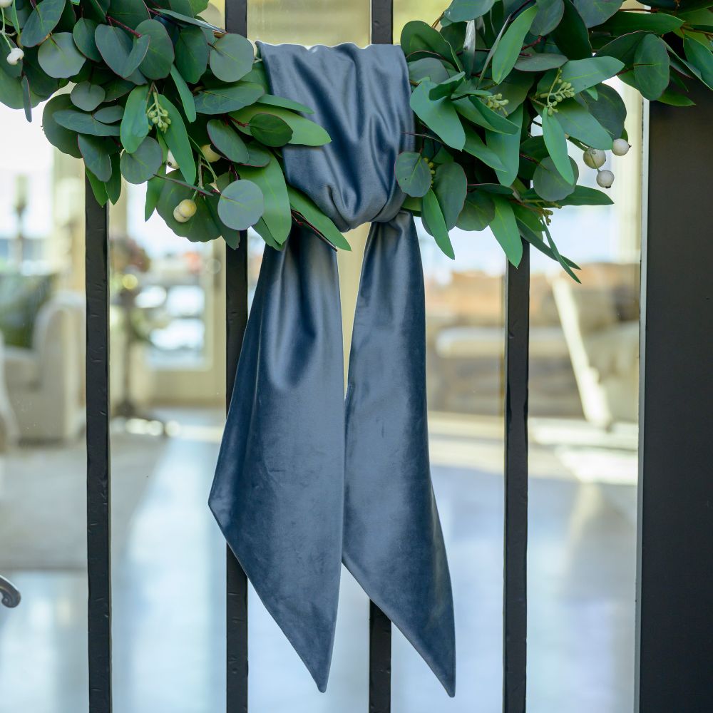 Green wreath with a French blue ribbon on a Door