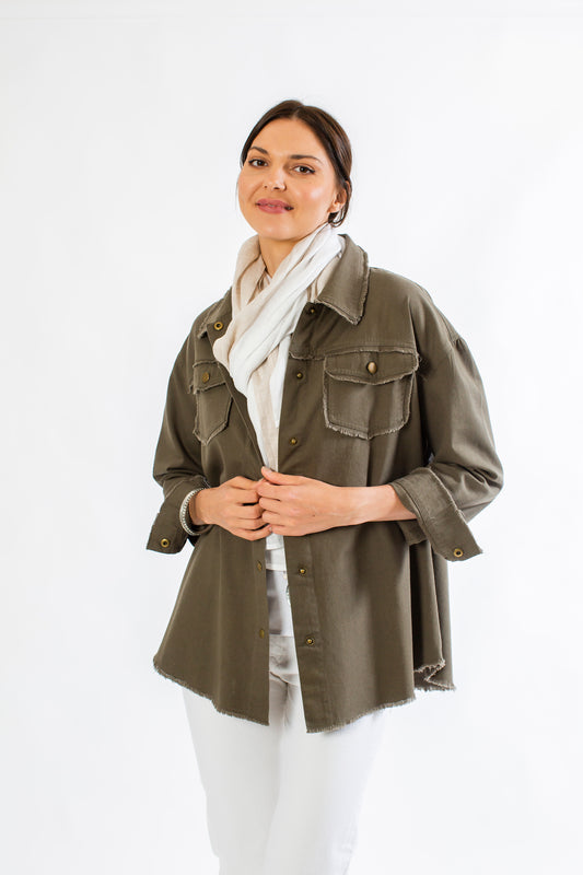 Woman posing in olive linen Emerson jacket with flax and white linen Stevie scarf. --Arte Italica and Crown Linen Designs