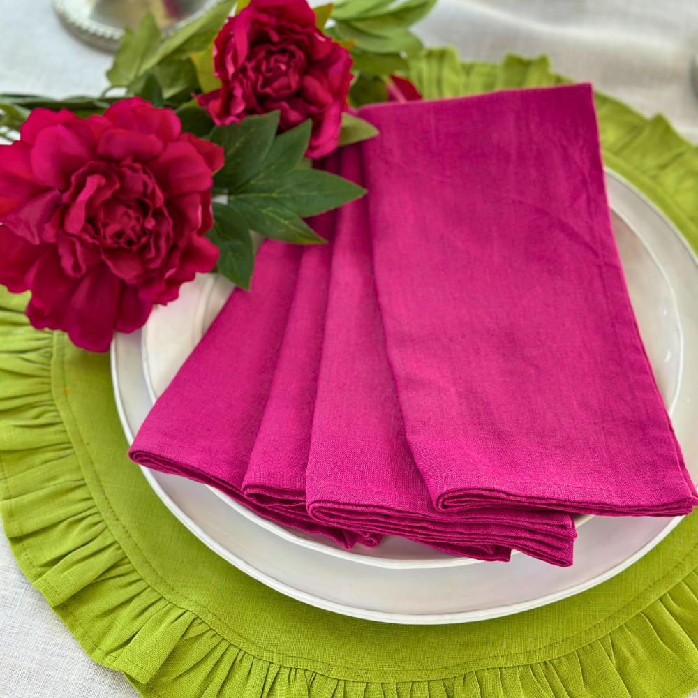 Washed Linen Napkin Set in Magenta displayed on a white Arte Italica plate with Flowers