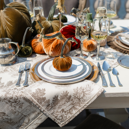 A fall table set with Velvet Hot Skwash pumpkins with Tuscan dinnerware and Montefalco cotton toile Napkin and Tablecloth in Latte color