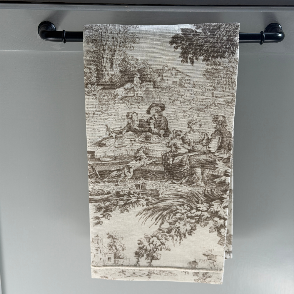Cream with Latte Montefalco toile cotton napkin hanging on a bar