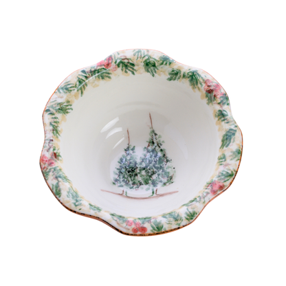 A hand painted Natale Italian ceramic small bowl with a scalloped edge on a plain white background