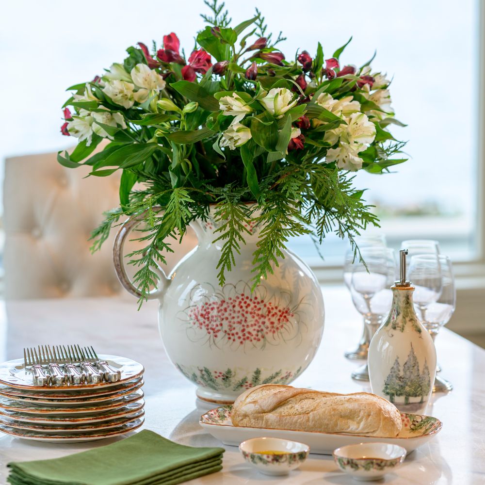 Decorative table setting with a floral arrangement in a Natale Large Pitcher used as a decorative vase.