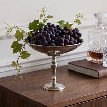 Arte Italica Peltro Italian Pewter Pedestal Bowl filled with grapes on a wooden sideboard — handcrafted in Italy
