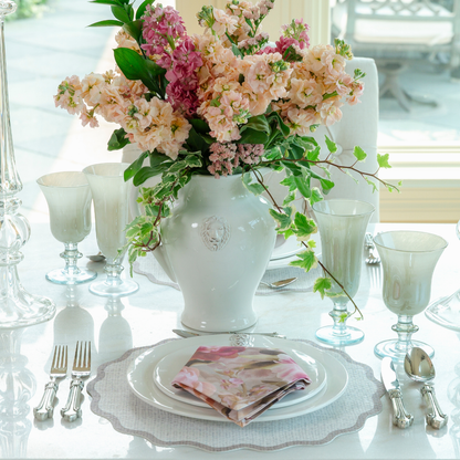 Rialto taupe glass flute and water wine on table with Leone pitcher with pink flowers and white dinnerware