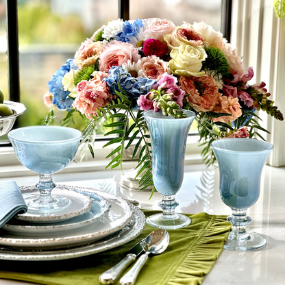 Rialto Blue Italian Water Wine Glass, Flute and Compote as part of a setting on a table with flowers - Arte Italica