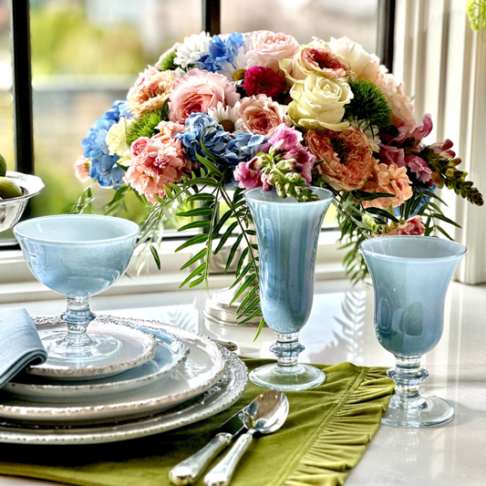 Rialto Blue Italian Water Wine Glass, Flute and Compote as part of a setting on a table with flowers - Arte Italica