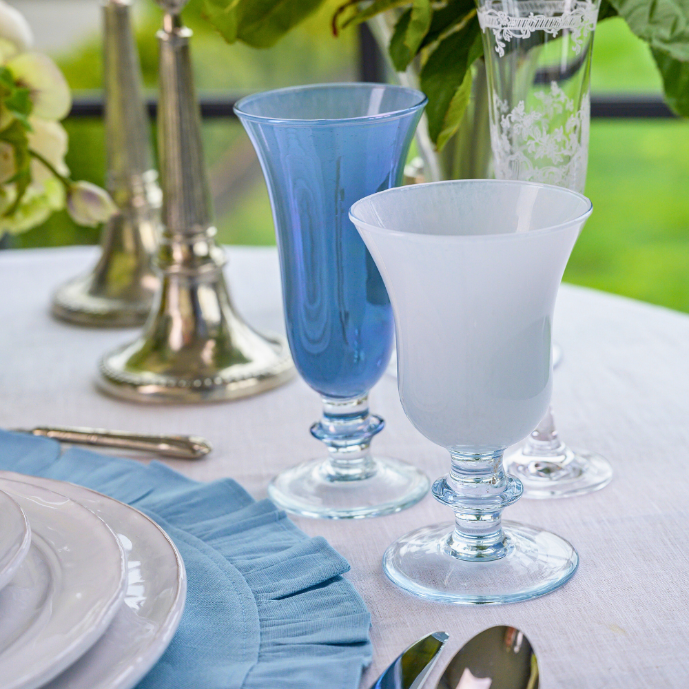 Rialto Blue Italian Flute and White Water Wine Glass on a table - Arte Italica