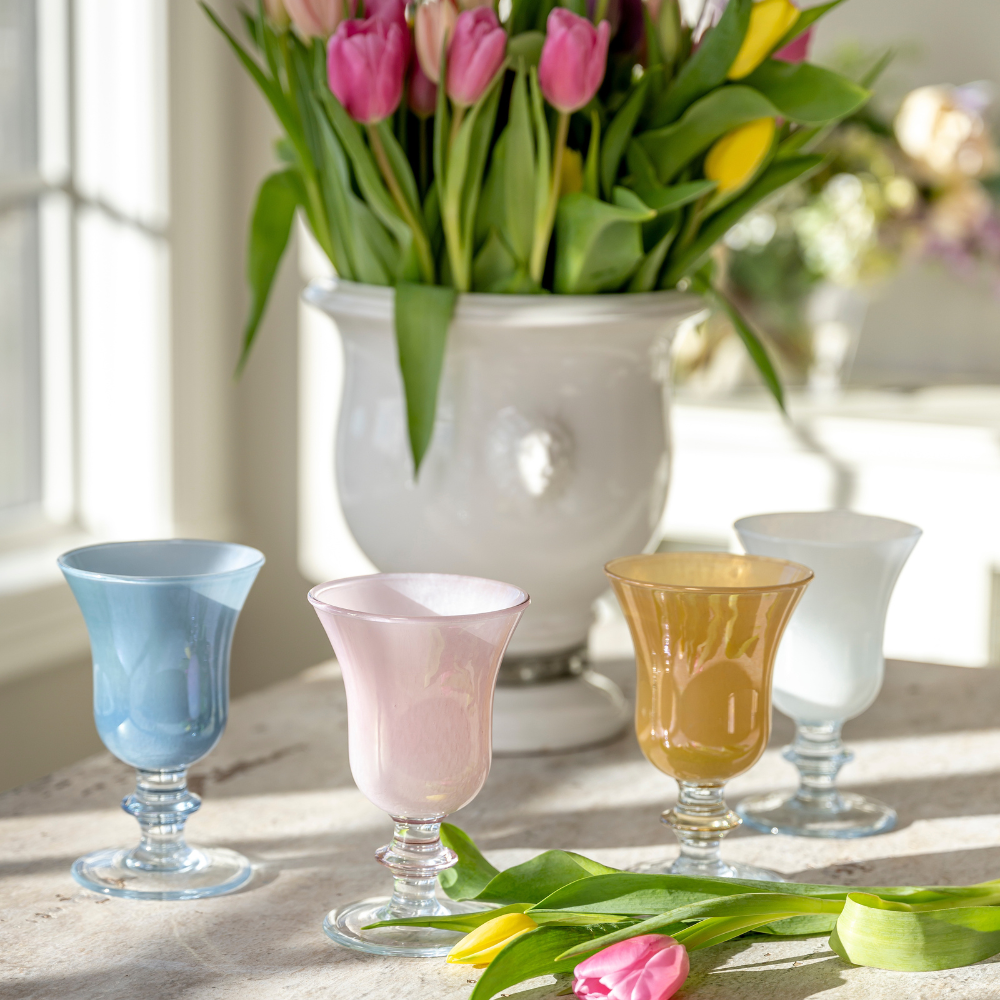 Rialto Italian Water Wine Glasses in Blue, Pink, Yellow and White on a table with tulips in a Leone urn - Arte Italica