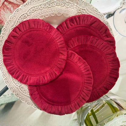 Round Ruffle Velvet Coaster Set in Garnet spread out on a Finezza Plate