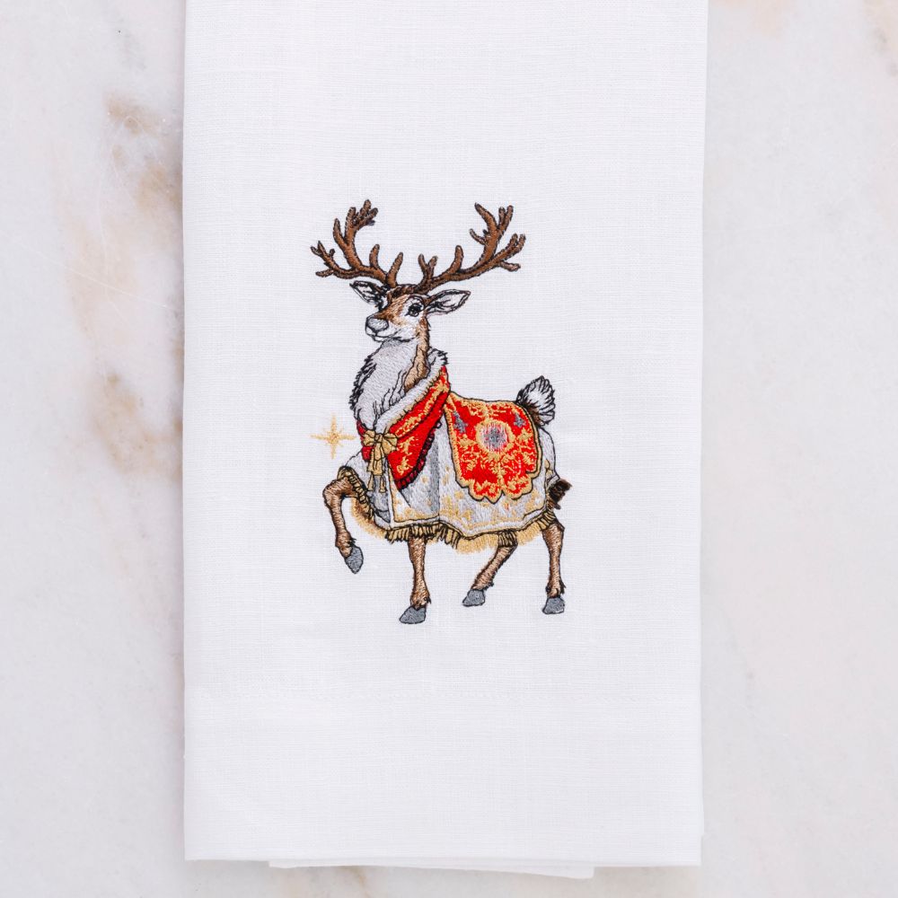 Embroidered reindeer with a red and gold pattern on a white Linen hand towel by Crown Linen Designs